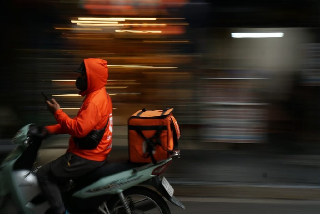 Livreur à moto circulant en ville